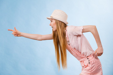 Woman wearing summer outfit pointing