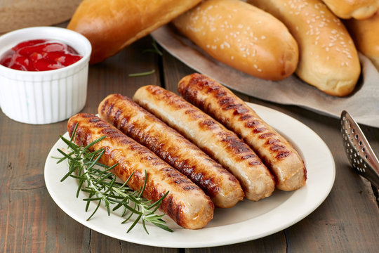 Grilled sausages with buns and sauce