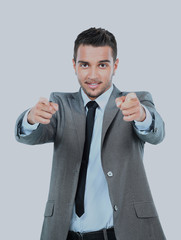 young businessman pointing with both hands at you against on white background.