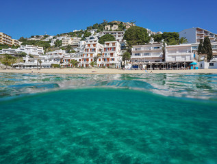 Fototapeta premium Above and below sea surface, Mediterranean beach with buildings and sand underwater, Spain, Costa Brava, playa Almadrava, Canyelles Grosses, Roses, Girona, Catalonia