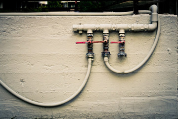 Irrigation pipes attached to a building wall