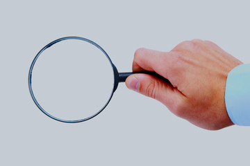 Magnifying glass in hand isolated on white background.