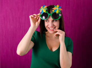 Woman wearing party glasses celebrates St. Patrick's Day