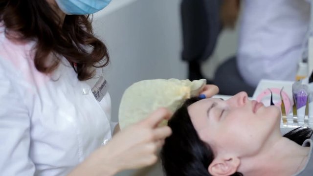 Beautician beauty woman puts on a hat