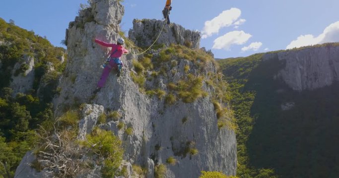 Aerial of climbers approaching the top protecting each other.
