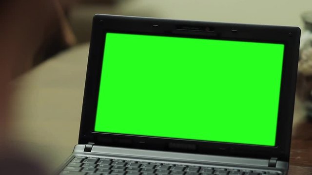 Netbook Computer with Green Screen. Close Up. Zoom In.  You can replace green screen with the footage or picture you want with “Keying” effect in After Effects  (check out tutorials on YouTube). 