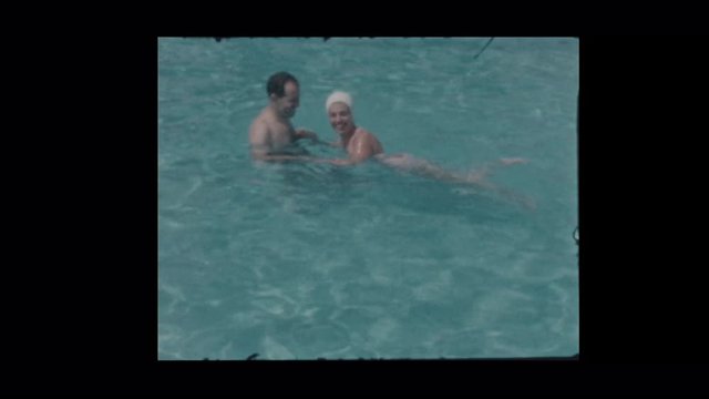 1958 Husband and wife play around in pool