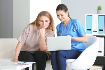 Young female doctor consulting overweight woman in clinic