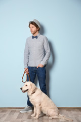 Handsome young hipster with dog indoors