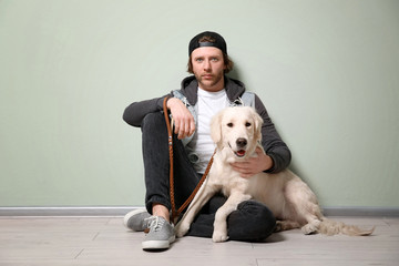 Handsome young hipster with dog indoors