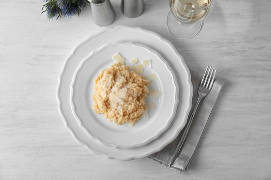 Plate with delicious risotto on table