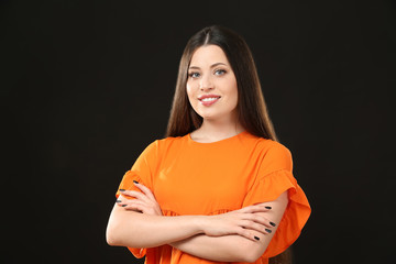 Obraz premium Portrait of beautiful smiling woman on black background