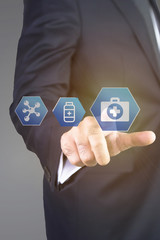 Close up of businessman touching medical icon with finger 