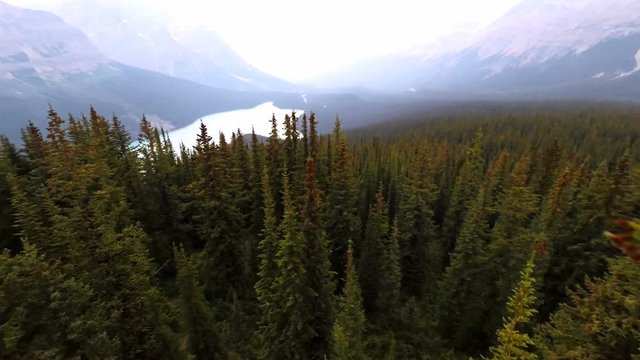 Aerial flythrough of beautiful emerald lake and mountains in Canada