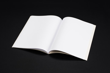 Mock-up magazine, book or catalog on black table. Blank page or notepad on solid background. Blank page or notepad for mockups or simulations.