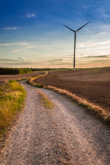 Fototapeta na wymiar Wonderful sunset at countryside with wind turbine, Europe