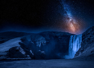 Milky way and spectacular Skogafoss waterfall in Iceland
