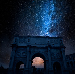 Fototapeta premium Famous Triumphal arch in Rome at night with stars, Italy