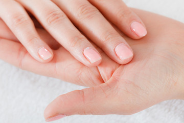 Woman presenting her beautiful painted gel hybrid nails