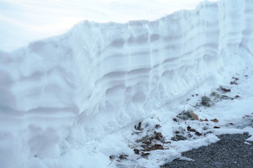 Accumulated snow in layers outdoor in winter