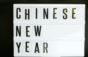 Pieces of transparent english text arrange on illuminated lightbox represent chinene new year concept background scene.