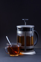 Glass teapot and cup with tea.