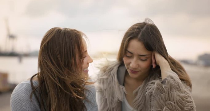 Girl giving her friend private tutoring in an industrial area