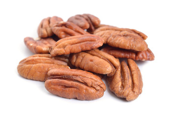 Pecan nuts pile on white background isolated