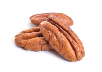 Pecan nuts pile on white background isolated
