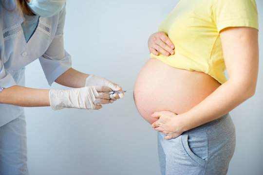 Doctor vaccinating a pregnant woman