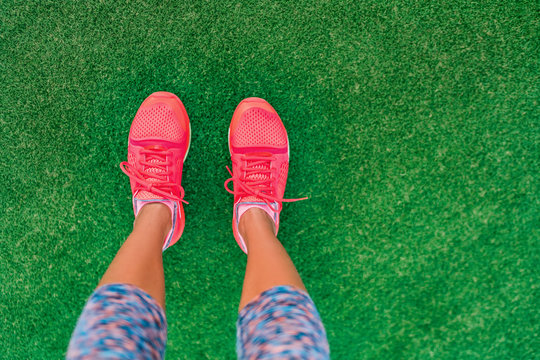 Fitness And Health Concept. Top View Of Running Shoes Woman Standing On Grass Pov Selfie Of Feet During Exercise Run Workout Outdoors. Sport And Active Lifestyle.