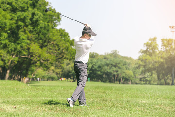 Asian men playing golf. men play golf while standing on field