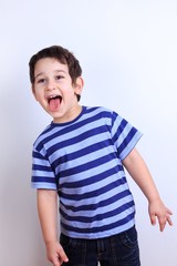 Naughty little boy showing tongue, close up studio shoot on white. Emotions, feelings, states of mind, childhood concept