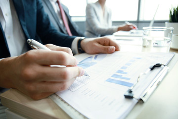 Fototapeta premium Working business people analyse high performance marketing data.