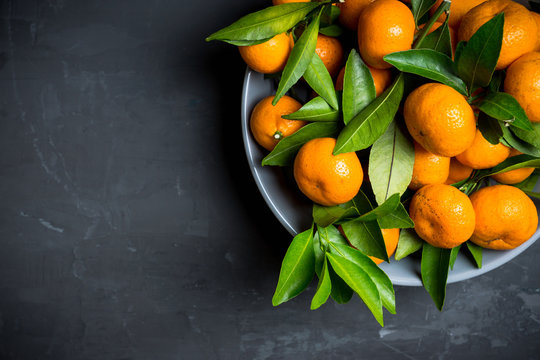 Mandarines on the rustic wooden background. Selective focus. Shallow depth of field.