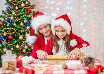 Fototapeta na wymiar mom teaches her daughter to cook Christmas cookies