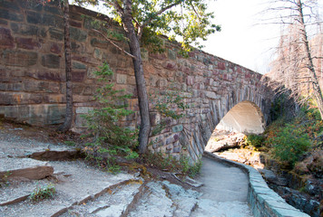 STONE BRIDGE OVER BARING CREEK ON THE GOING TO THE SUN ROAD IN GLACIER NATIONAL PARK IN MONTANA UNITED STATES
