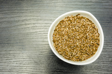 Brown flaxseeds in a bowl. View from above.