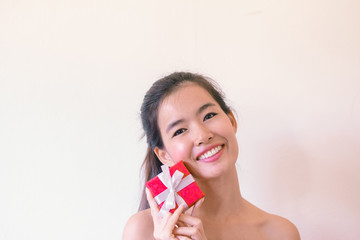 Beauty Skincare concept- Young Asian woman after shower  smiling holding velentine’s red box present