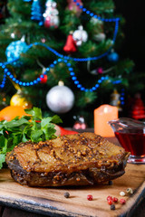 Fototapeta na wymiar Duck breast - Magret with berry sauce on the background of Christmas decorations. Christmas menu. French cuisine. Festive dish.