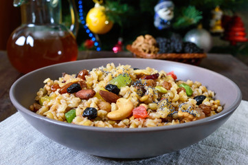Wheat porridge with different nuts, dried berries, poppy seeds, raisins, honey. Kutya. Christmas dish of the Slavs.
