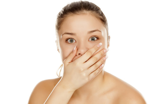 young shocked,girl without makeup on white background