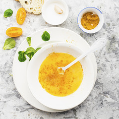 Ingredients for cooking scrambled eggs or omelets with green herbs, fresh vegetables, broccoli and turmeric as a healthy breakfast or lunch option. View from above. Against a light background.