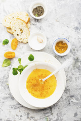 Ingredients for cooking scrambled eggs or omelets with green herbs, fresh vegetables, broccoli and turmeric as a healthy breakfast or lunch option. View from above. Against a light background.