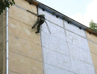 Builder at the height of the house repairs .