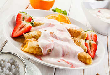 Crepes with strawberries and cream
