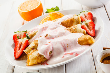Crepes with strawberries and cream