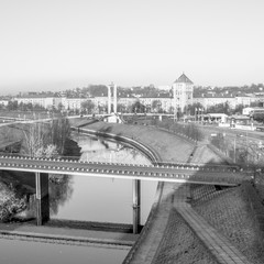 Black and white photography of city scape. River, bridges and historical buildings in Kaunas city.