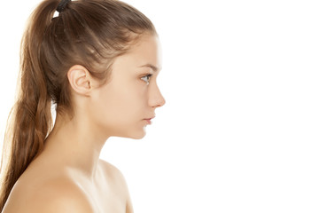 profile of young girl without makeup on white background