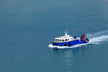 Blue and White Boat in Barcelona Harbor